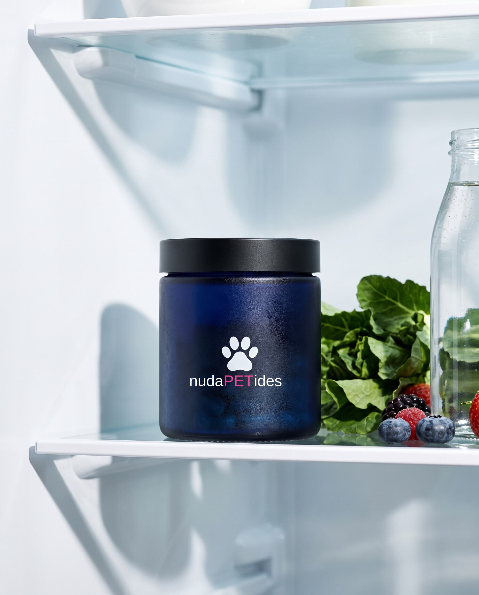 nudaPETides navy jar on a refrigerator shelf with fresh produce